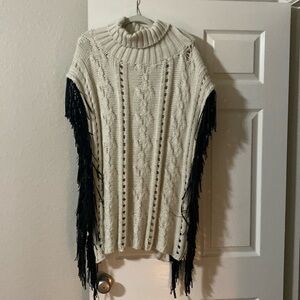 Cream colored sweater turtleneck pull over with leather fringe accent
